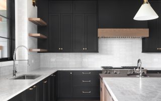 black kitchen with stainless steel appliances.