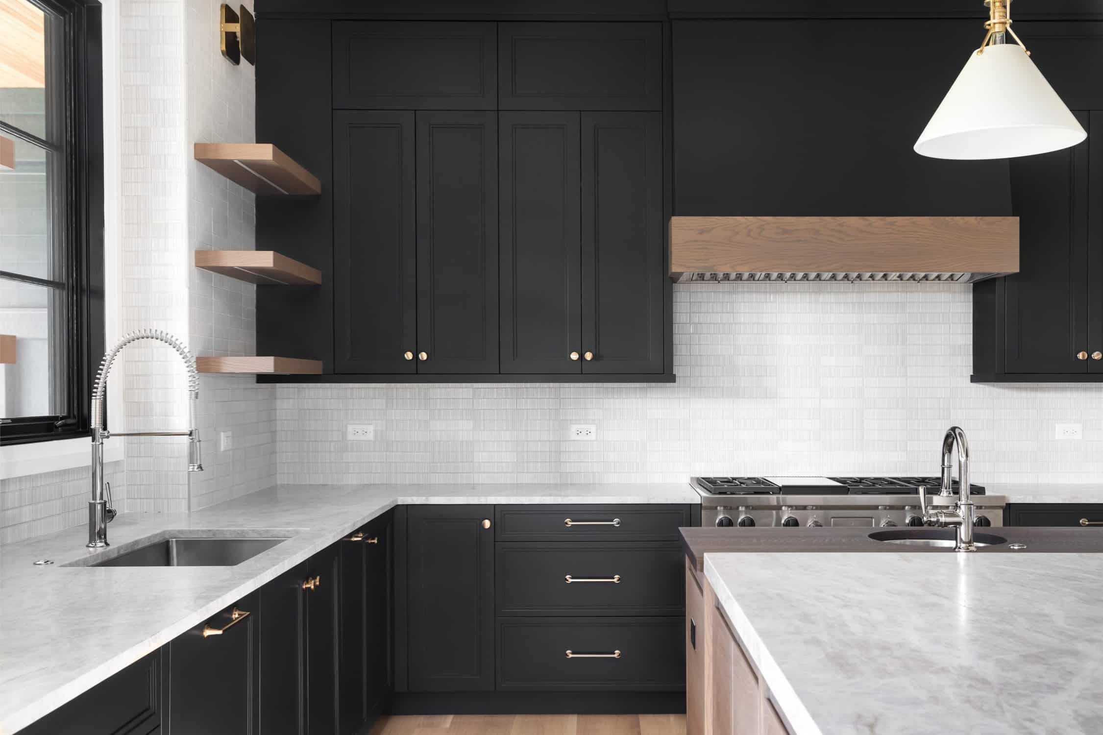 black kitchen with stainless steel appliances.